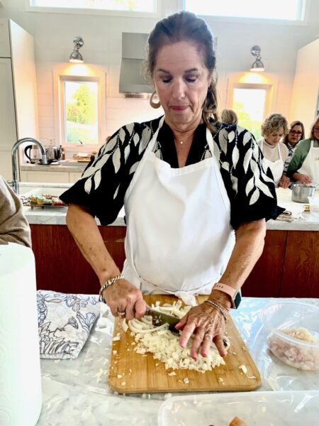 Chopping onions during a hands-on class at Ethos Culinary.